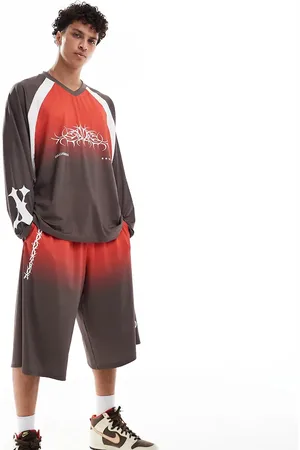 COLLUSION Longline track shorts in black and (part of a set)