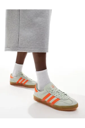 adidas Gazelle Indoor sneakers in light green and orange with gum sole