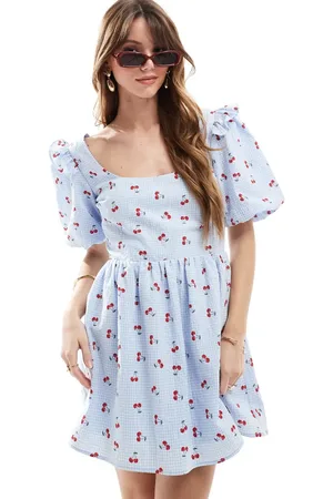 The Frolic Exclusive seersucker ruffle puff sleeve shirred babydoll mini dress in and cherry print