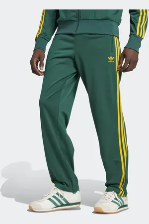 adidas Firebird track pants in green and yellow