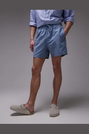 Tommy Hilfiger Drawstring flag taping swim shorts in blue-Navy