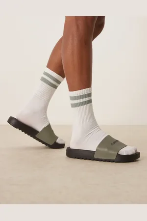 Calvin Klein Logo sliders in olive and black