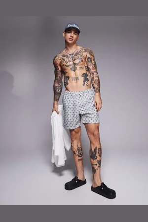 ASOS Swim shorts in mid length with geo print in
