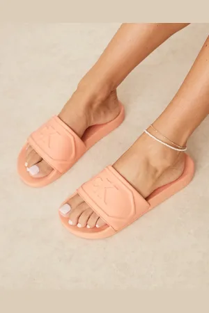 Calvin Klein Logo puff sliders in pastel orange