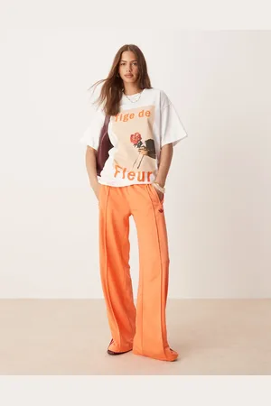 adidas Firebird loose track pants in orange