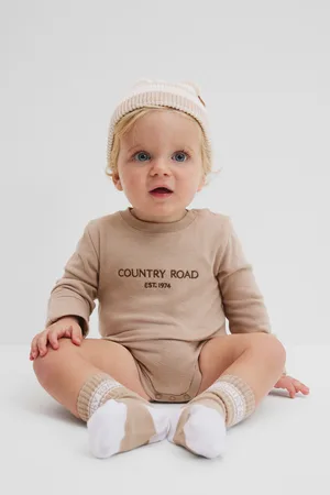COUNTRY ROAD Boys Organically Grown Contrast Logo Long Sleeve Bodysuit Mushroom in Size 6-12 Months | 100% Cotton