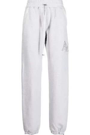 AMIRI Staggered logo-embroidered track pants