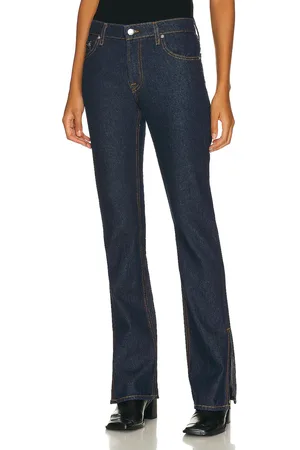 GRLFRND Hailey Low Rise Slim Boot With Slit Hem in - Denim-Dark. Size 29 (also in 30, 31, 32).