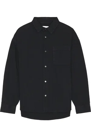 Frame Long Sleeve Relaxed Denim Shirt in - Black. Size S (also in ).